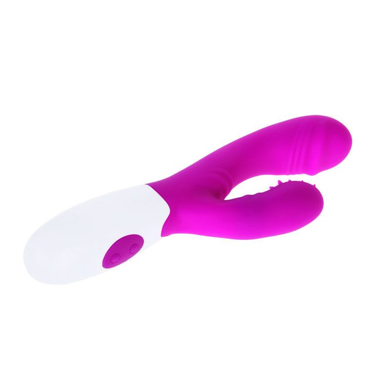 Lila Vibrator mit weißem Griff. Zwei Knöpfe am Griff. Gebogene Form mit strukturiertem Bereich. Auf weißem Hintergrund.