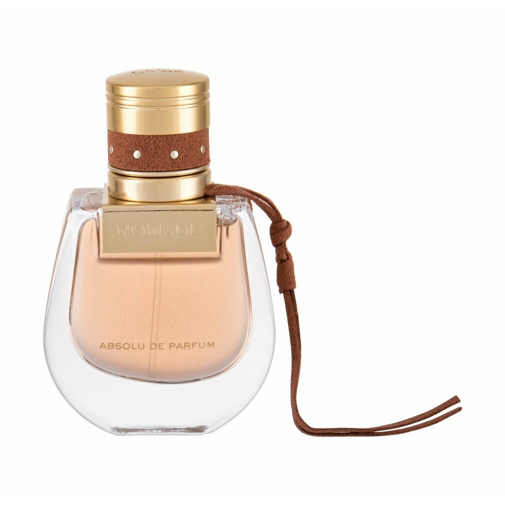 Parfümflakon mit goldfarbenem Deckel, braunem Lederband. Aufschrift 'Nomade Absolu de Parfum'. Transparenter Flakon.