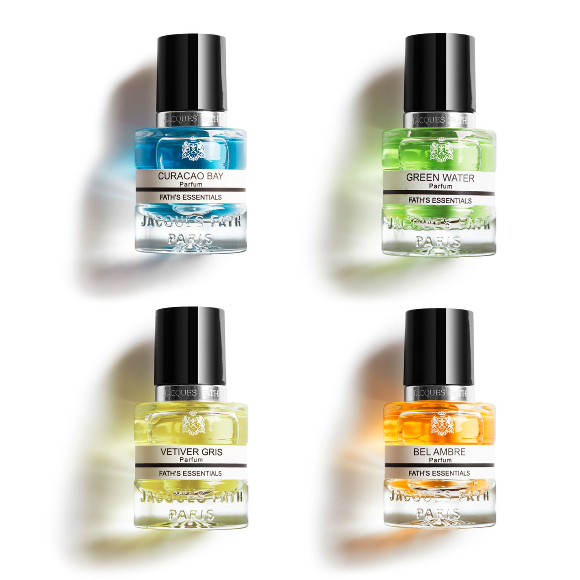 Vier kleine Parfumflakons mit schwarzen Kappen. Aufschrift: Jacques Fath, Fath's Essentials. Farben: Blau, Grün, Gelb, Orange.