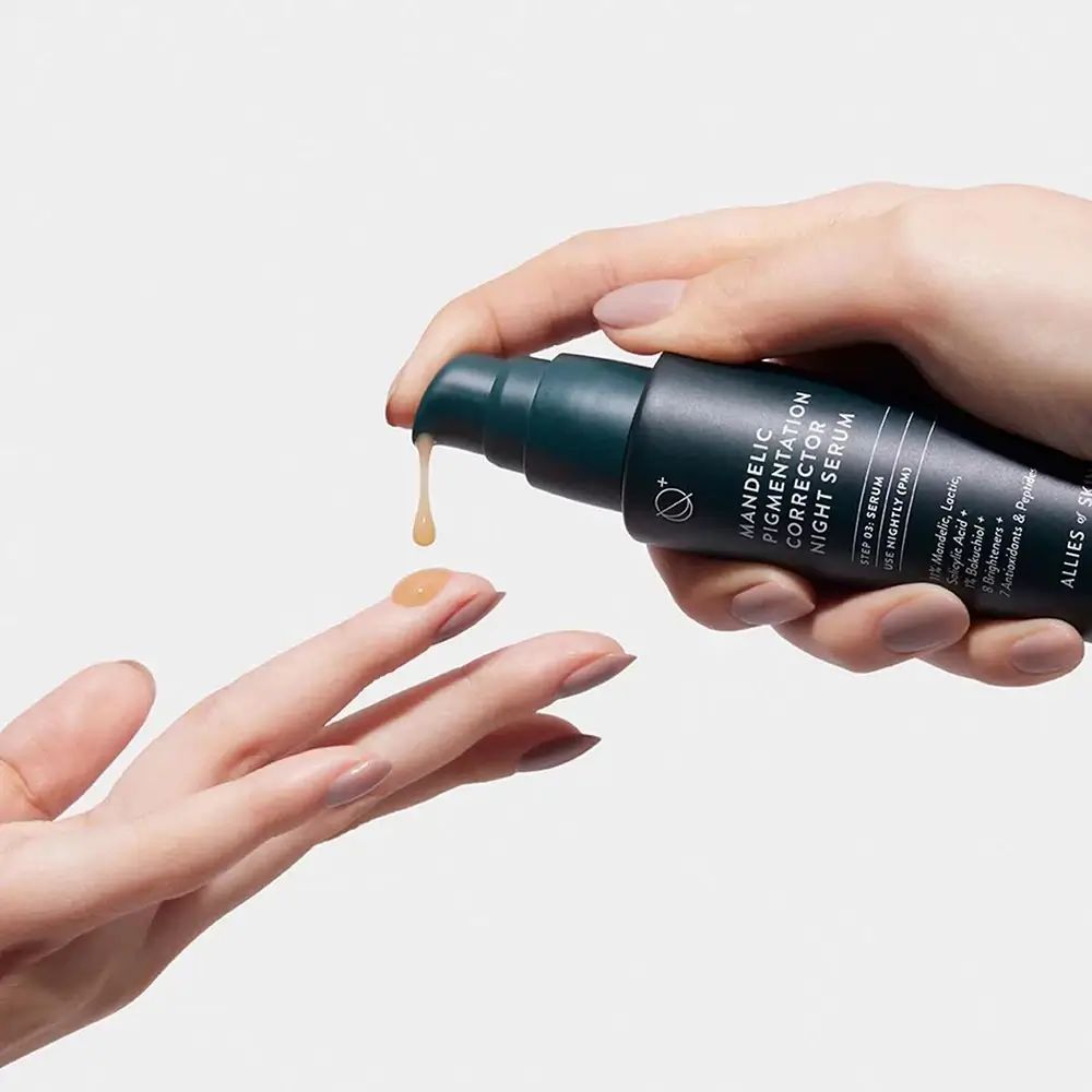 Hände halten Flasche und Produkt. Gelbliche Creme tropft aus der Pumpe.