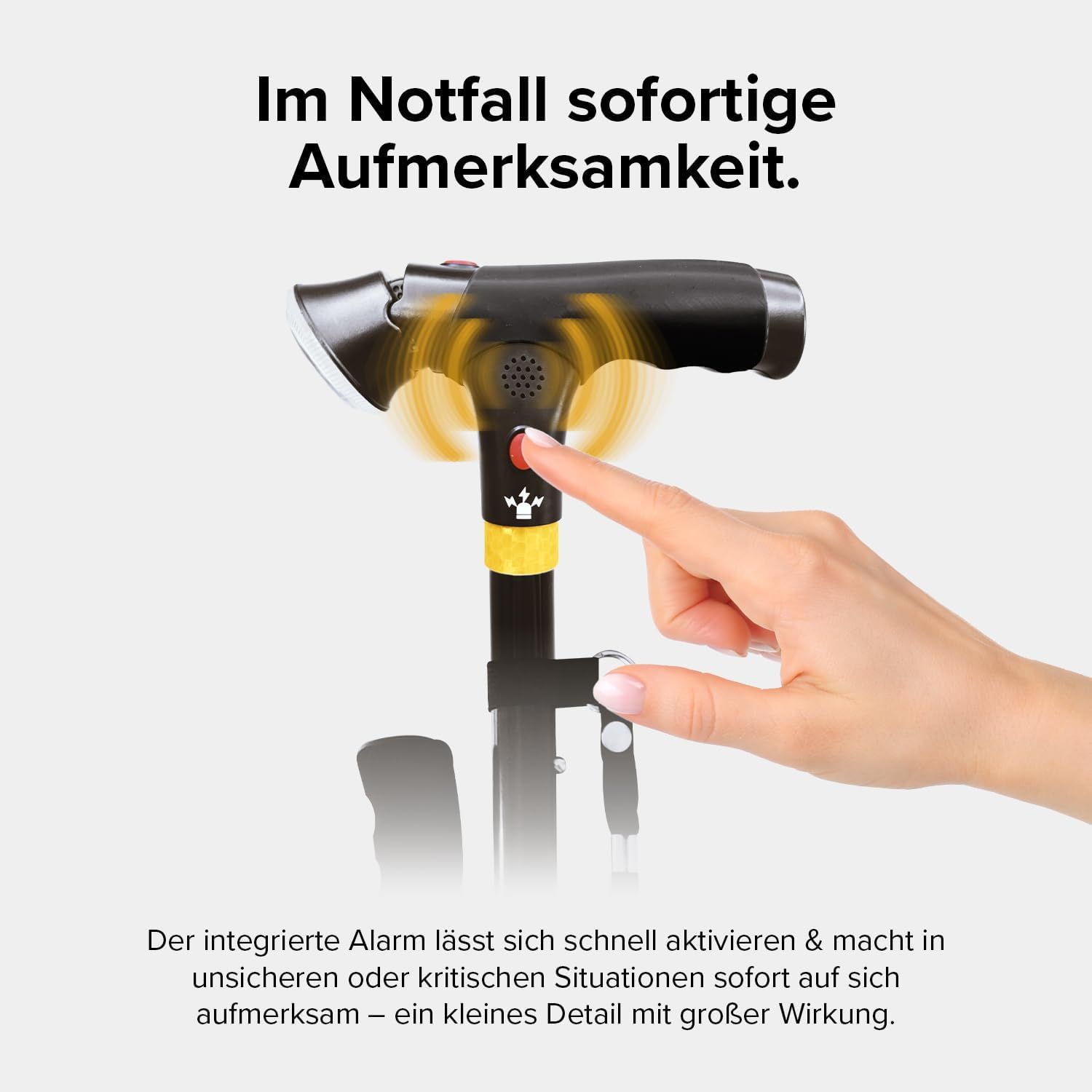 Finger drückt den roten Alarmknopf am Griff des DR-HO'S Gehstocks.