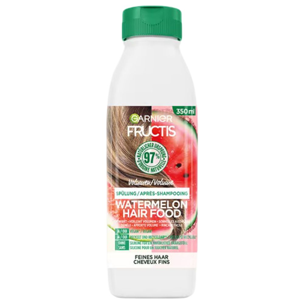 Garnier Fructis Volumen Spülung Flasche. Weiß, grüner Deckel. Produktname und Wassermelonen-Illustration.