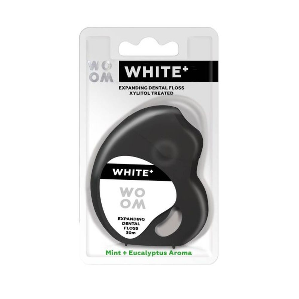 Zahnseide in Blisterverpackung. "WHITE+" und "WOOM" Schriftzug. "EXPANDING DENTAL FLOSS". "Mint + Eucalyptus Aroma".