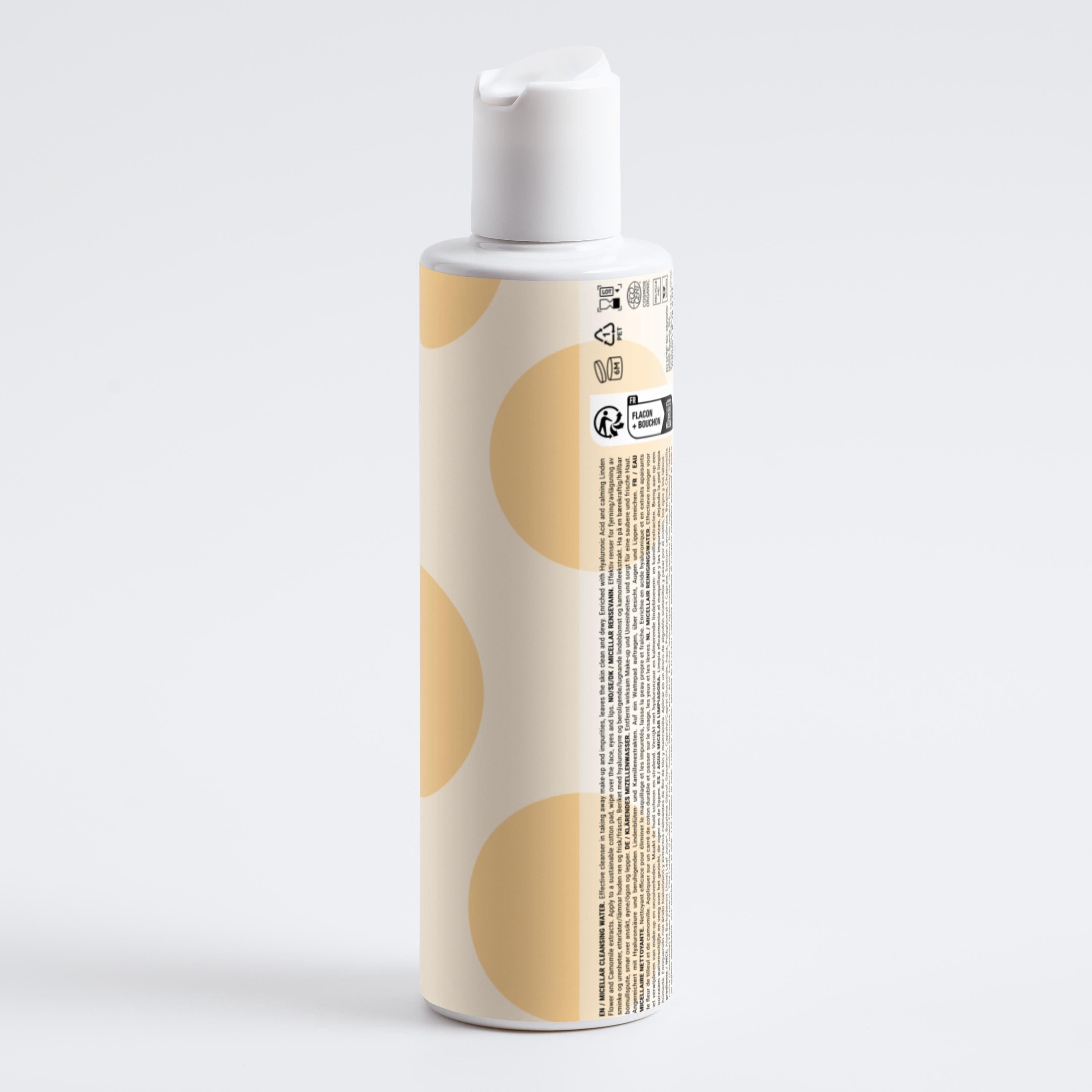 Beige Flasche mit weißem Deckel. Gelbe Kreise auf der Flasche. Text und Symbole auf der Rückseite.