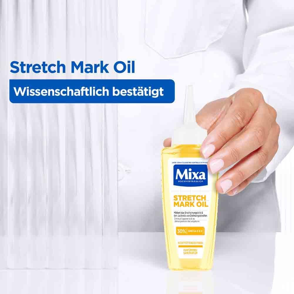 Person hält eine gelbe Flasche mit weißem Applikator. Aufschrift Mixa Stretch Mark Oil. Text: Wissenschaftlich bestätigt.