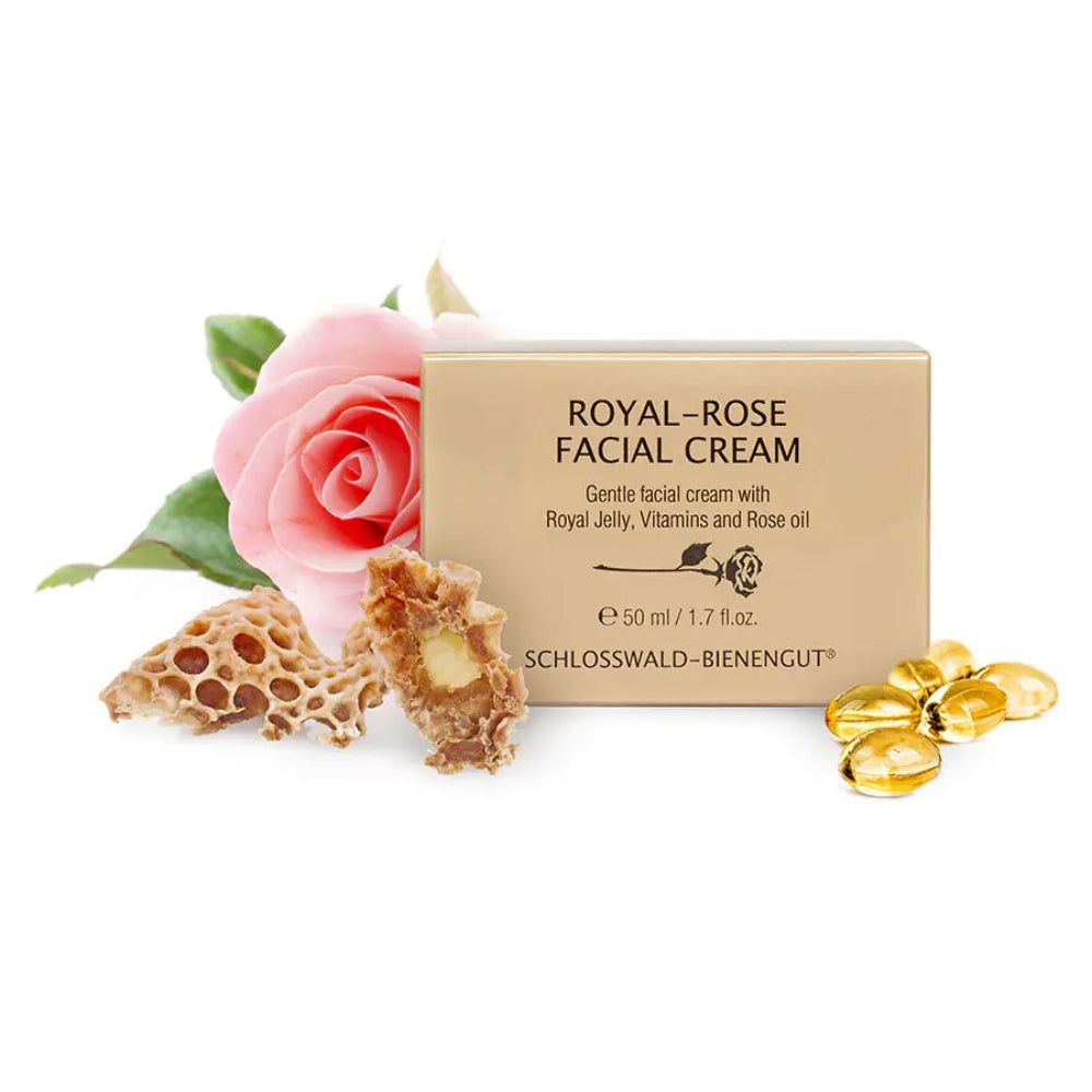 Beige Schachtel mit Aufschrift "ROYAL-ROSE FACIAL CREAM". Daneben Rose, Wabe und Kapseln. Produktname und Marke sichtbar.