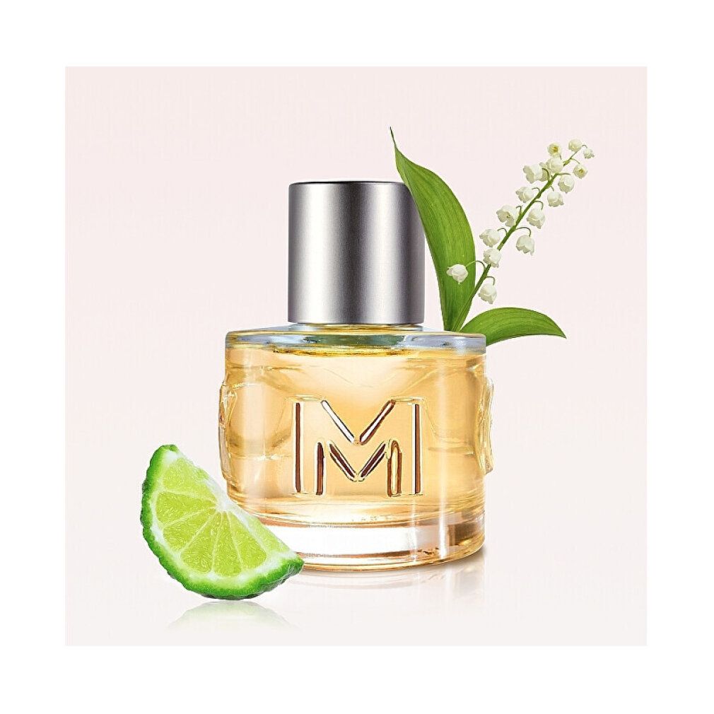 MEXX Woman Eau de Toilette Flakon mit Zitrone und Blumen. Zylindrische Glasflasche mit silbernem Verschluss.