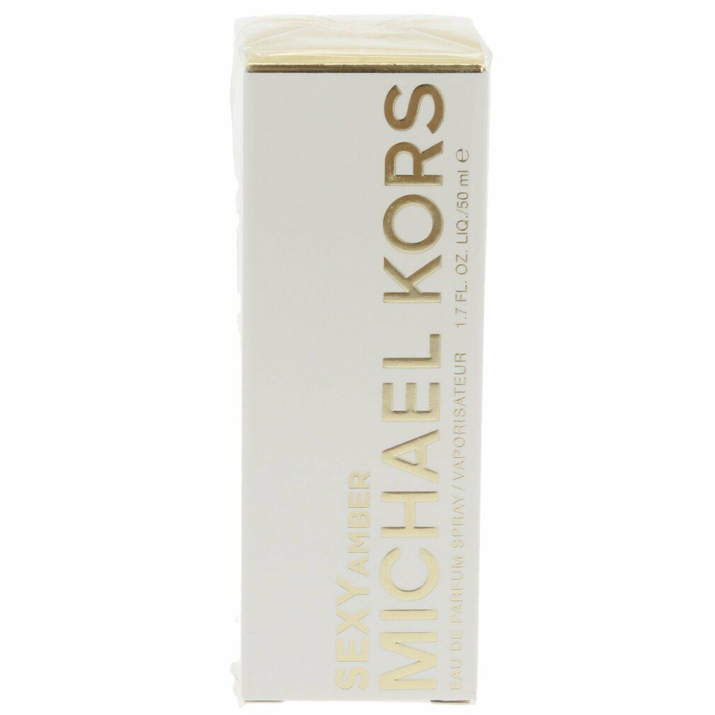 Verpackung mit MICHAEL KORS-Logo und Produktnamen. Text: SEXY AMBER, Eau de Parfum Spray.