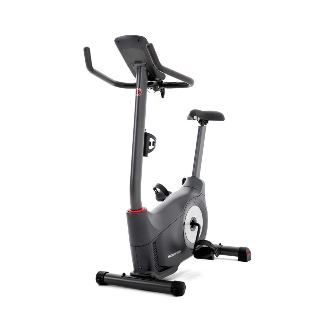 Hometrainer, schwarz. Sattel, Lenker und Konsole. Schwinn-Logo. Roter Akzent. Pedale und Flaschenhalter.