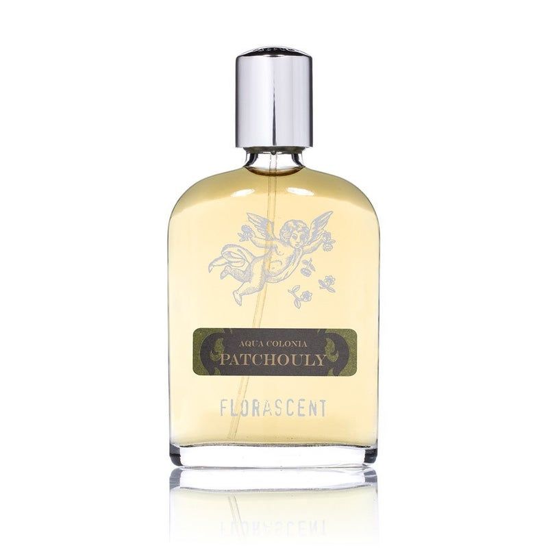 Parfümflakon mit silbernem Verschluss. Aufschrift: Patchouly, Aqua Colonia, Florascent. Engel-Illustration.