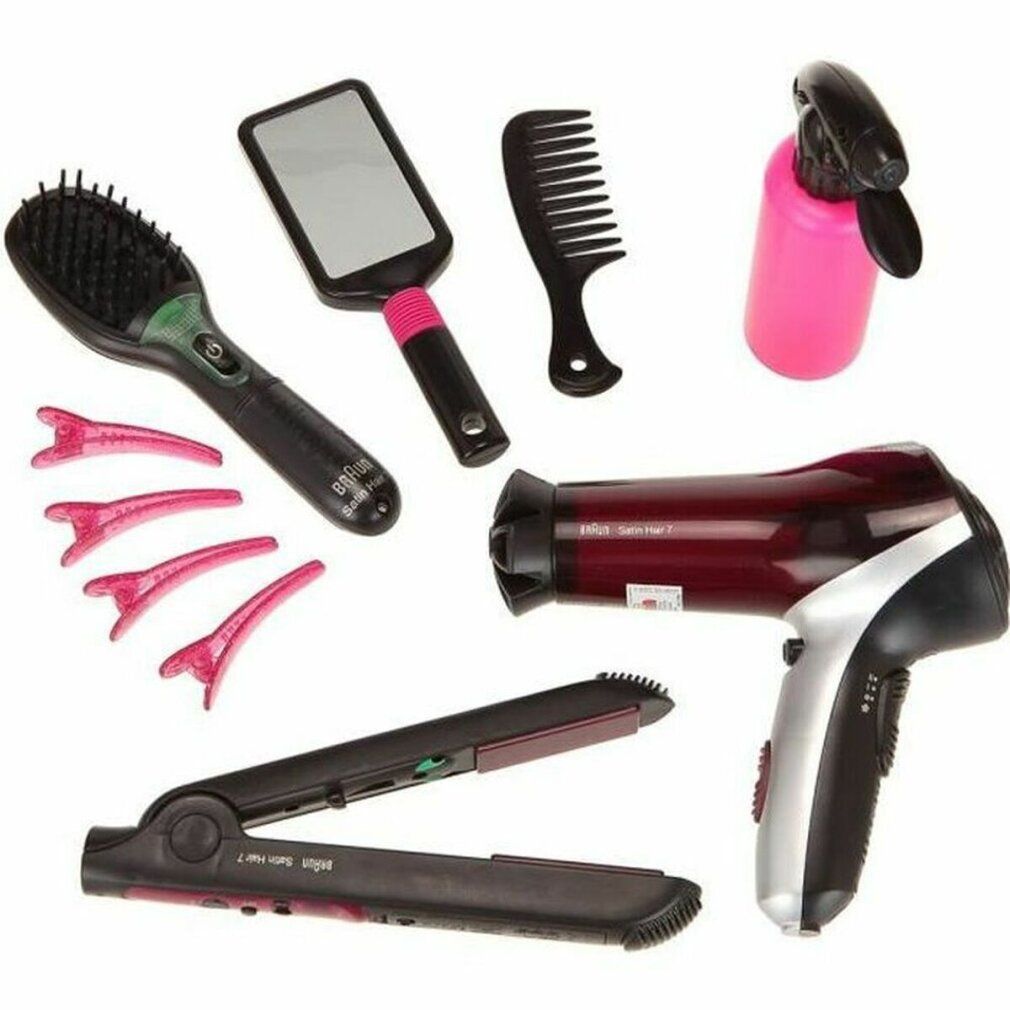 Frisier-Set mit Haartrockner, Glätteisen, Bürste, Spiegel, Kamm, Haarklammern und Sprühflasche. Schwarze und rosa Elemente.