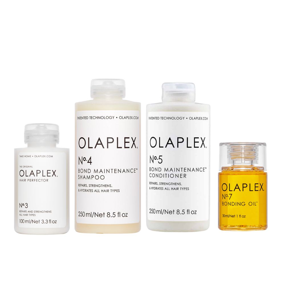 Vier Olaplex-Haarpflegeprodukte: No.3, No.4 Shampoo, No.5 Conditioner und No.7 Bonding Oil. Flaschen mit weißem Etikett und schwarzer Schrift.