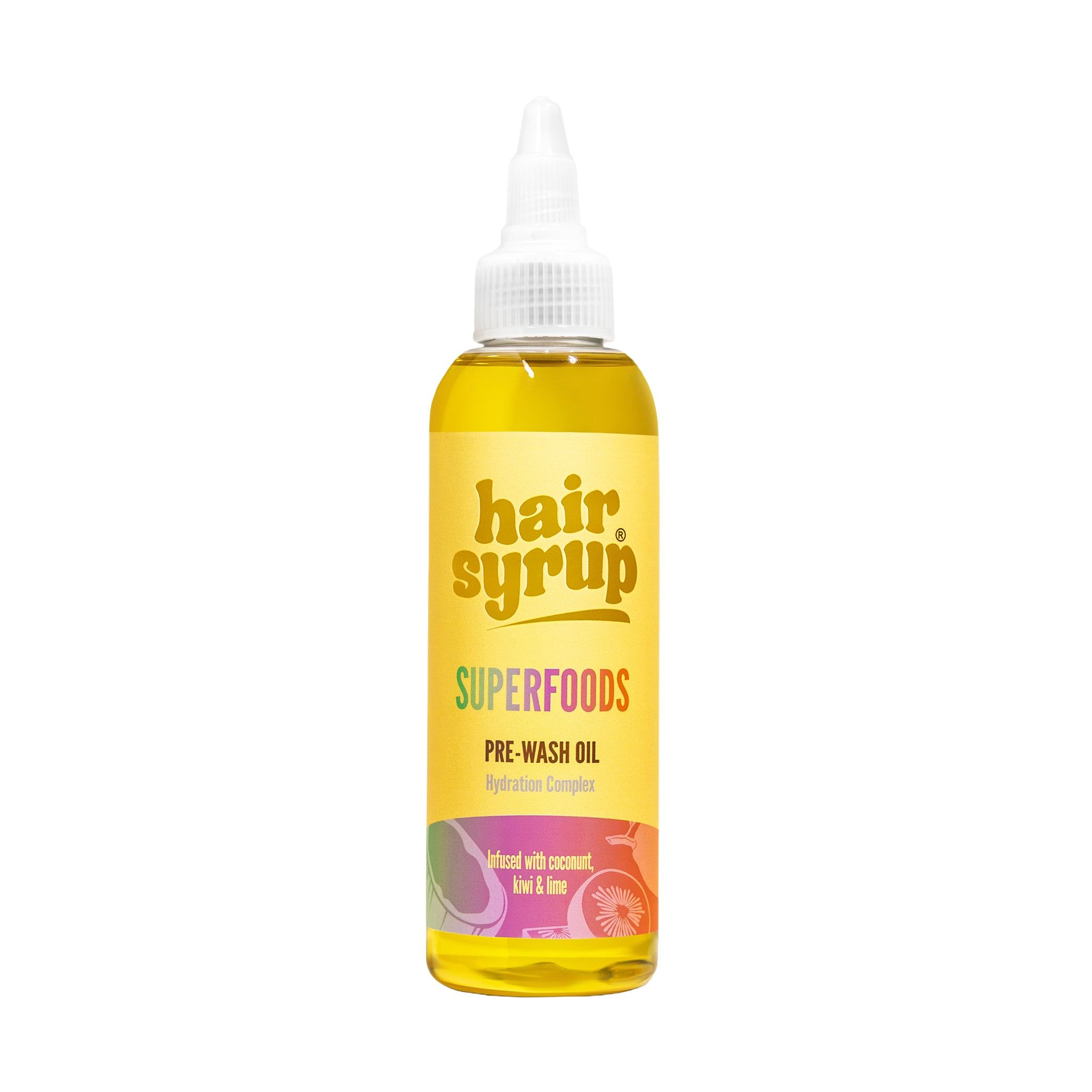 Gelbe Flasche mit spitzer Kappe. Aufschrift: Hair Syrup Superfoods Pre-Wash Oil. Mit Kokosnuss, Limette & Ingwer.