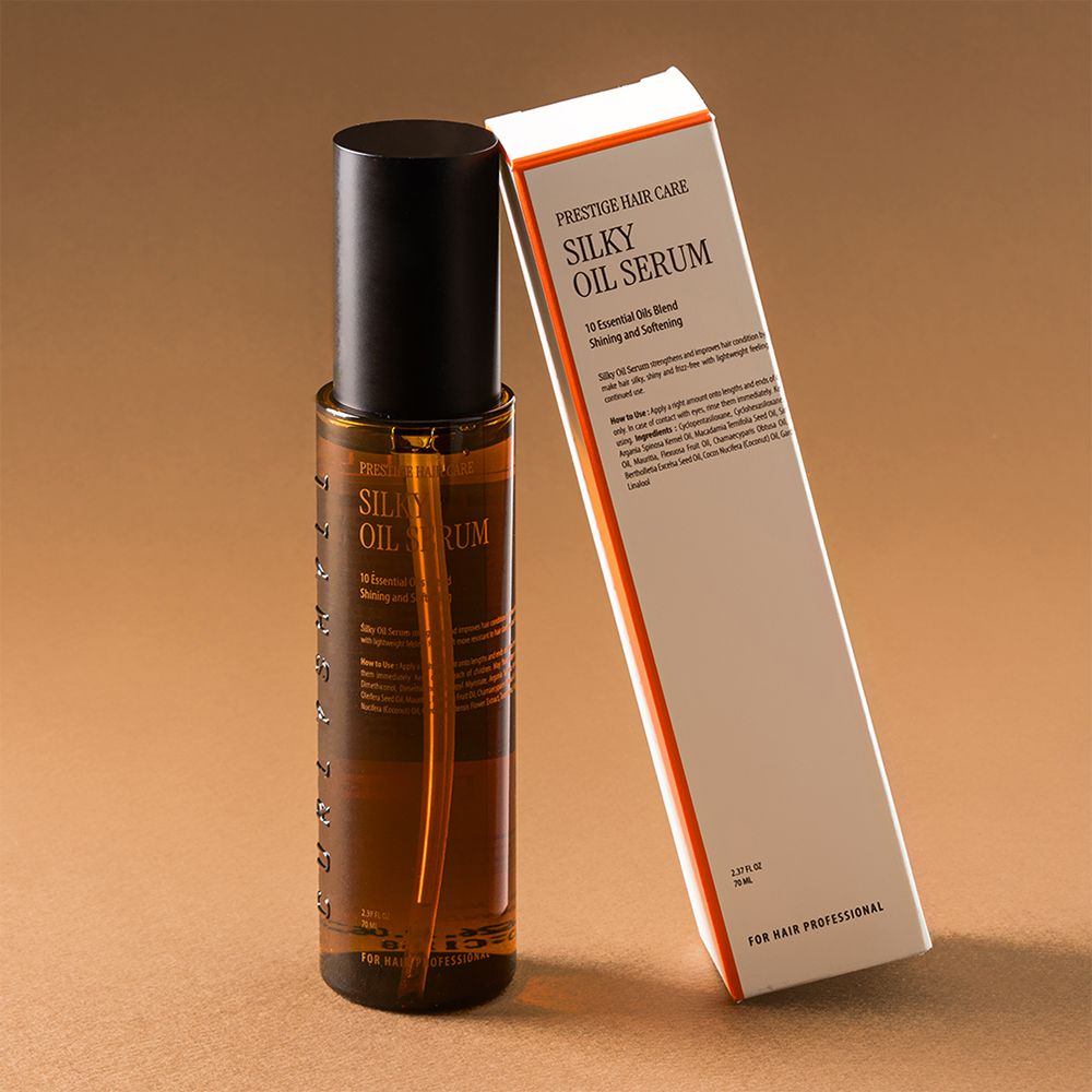 Braune Haarölflasche und Verpackung. Aufschrift: Silky Oil Serum. Für professionelle Haarpflege. Weiße Verpackung.