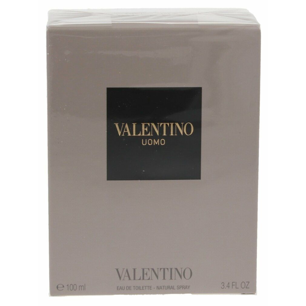 Verpackung von Valentino Uomo Edt Spray. Rechteckige, graue Schachtel mit schwarzem Etikett und goldener Schrift.