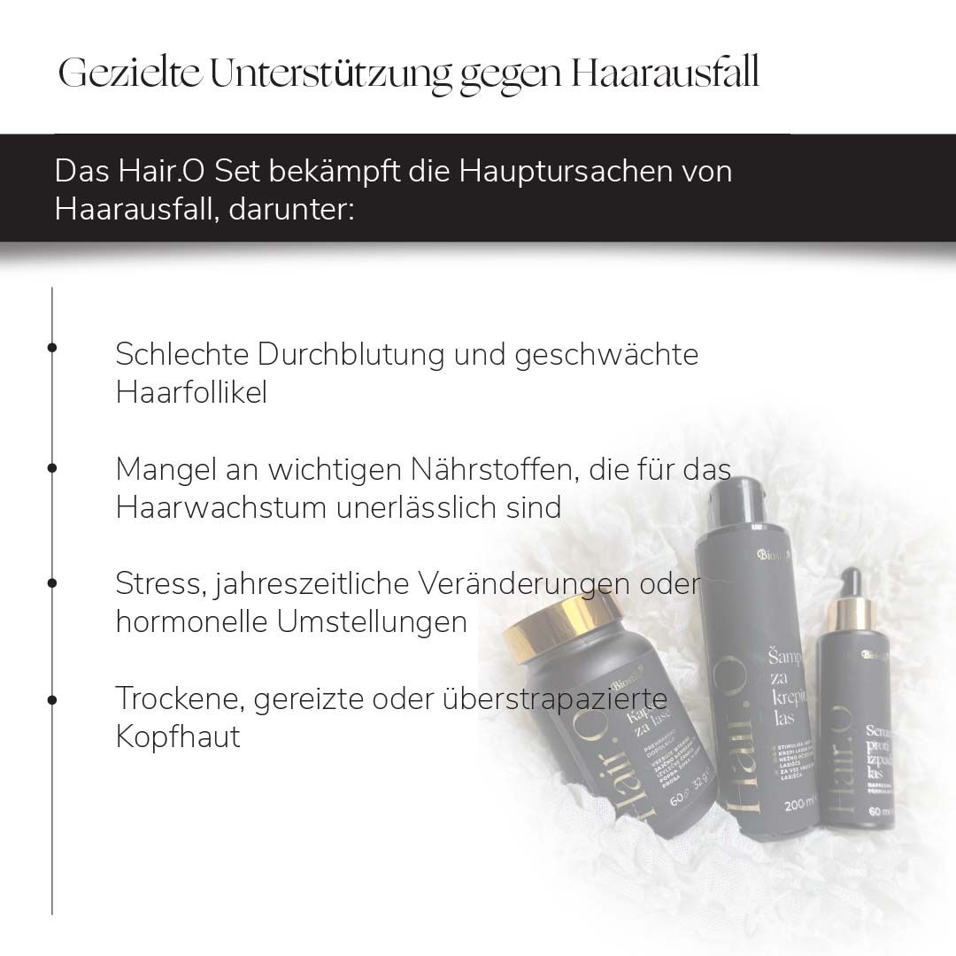 Biostile Hair.O Set: Shampoo, Serum und Kapseln auf einem Holzpodest, umgeben von weißen Blüten.