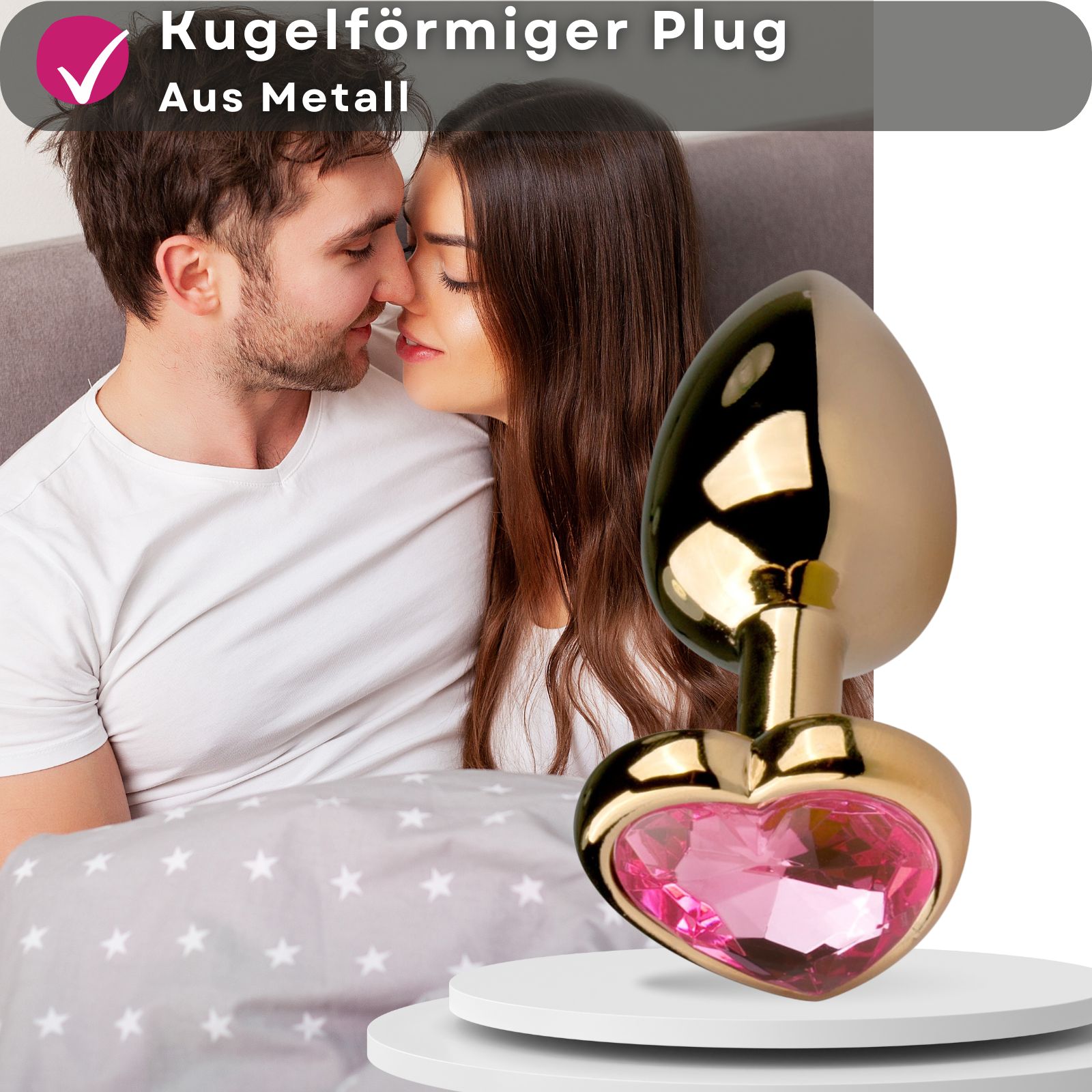 Goldfarbener Analplug mit herzförmigem Zierstein. Rosa Zierstein.