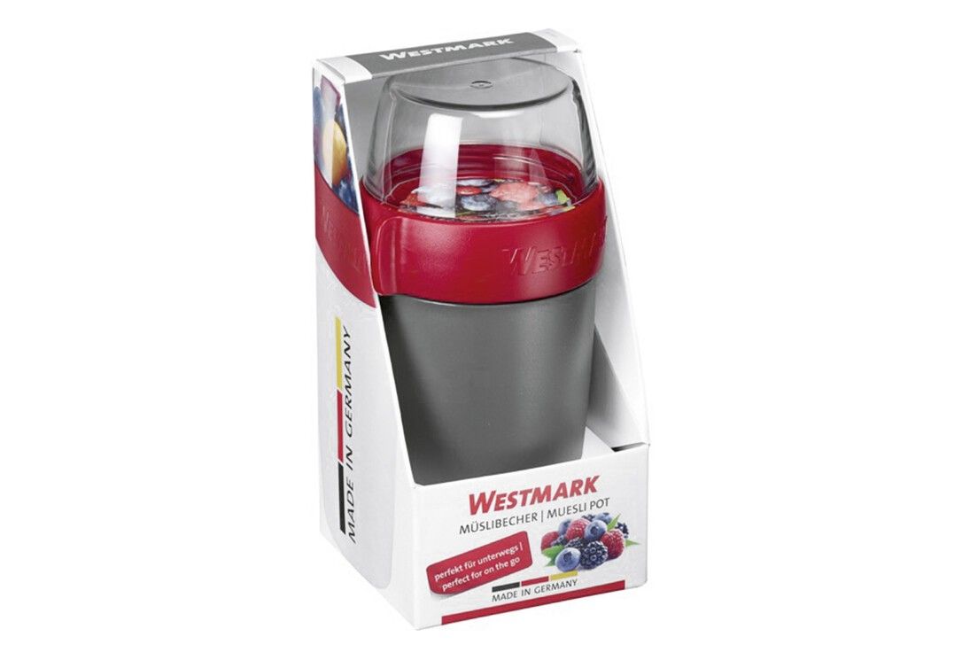 Müslibecher in Verpackung. Schwarzer Becher mit rotem Band und transparentem Deckel. Text: WESTMARK Müslibecher, Made in Germany.