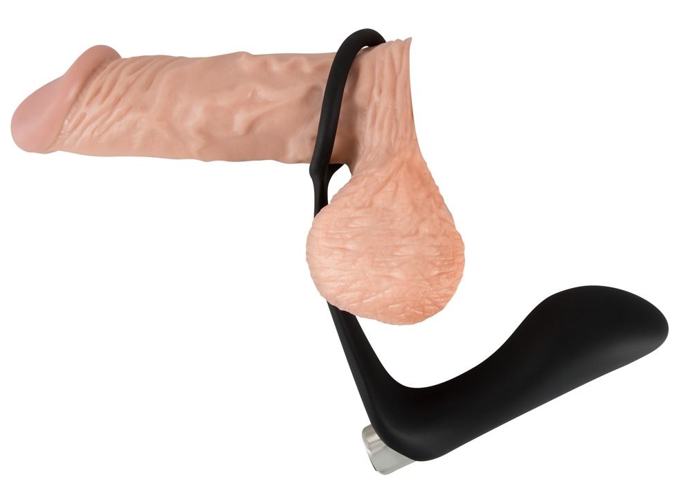 Penis und Hoden mit schwarzem Penisring. Ringförmiger Teil um den Penis, Schaft unterhalb der Hoden.