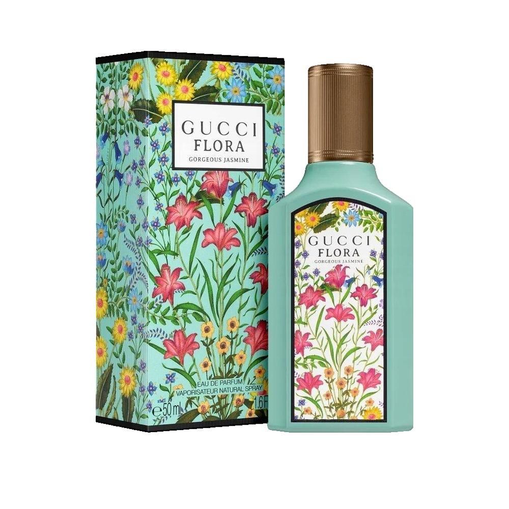 Türkisgrüner Flakon und Schachtel mit floralem Muster. Aufschrift Gucci Flora Gorgeous Jasmine. Goldfarbener Deckel.