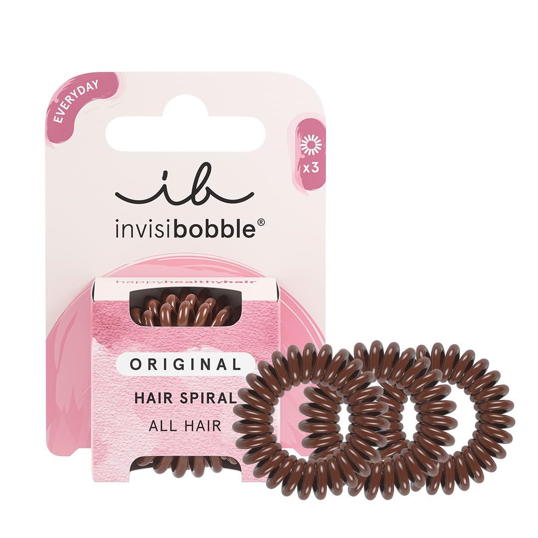 Verpackung mit drei braunen Haargummis in Spiralform. Marke: Invisibobble. Aufschrift: Original Hair Spiral.