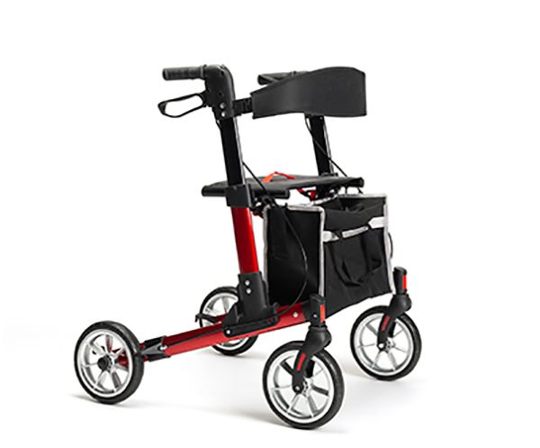 Rollator, rot und schwarz. Vier Räder, Einkaufstasche, Sitzfläche und Handgriffe. Silberne Felgen.