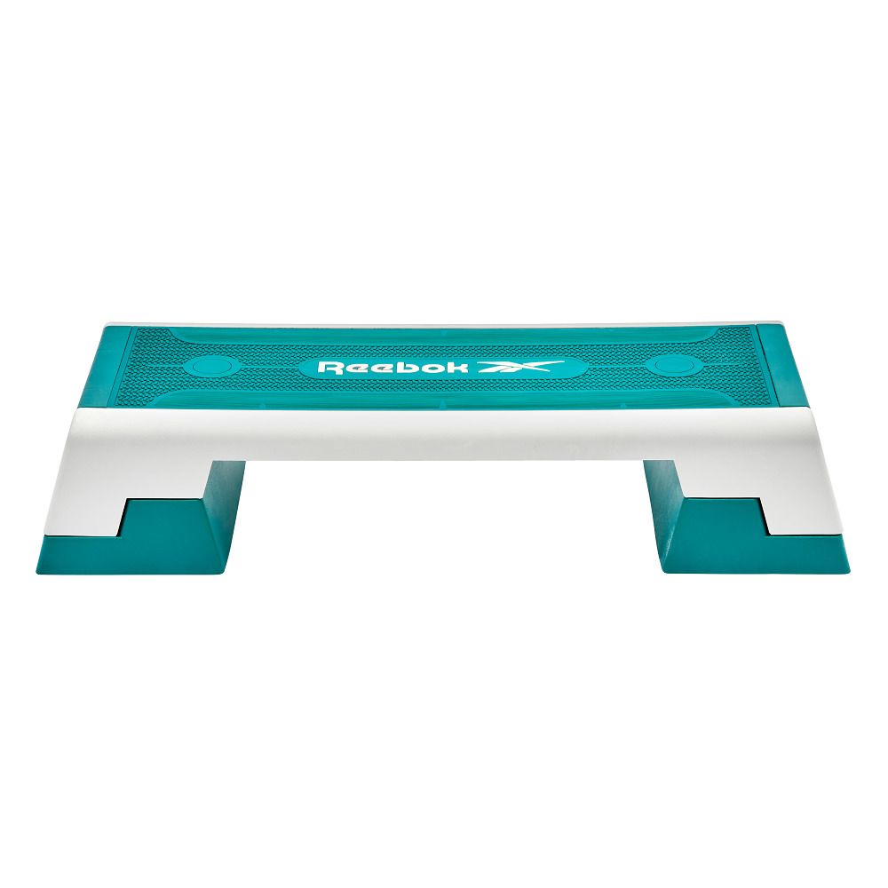 Reebok Step, teal und weiß. Rechteckige Form mit zwei Stützfüßen. Reebok Logo.