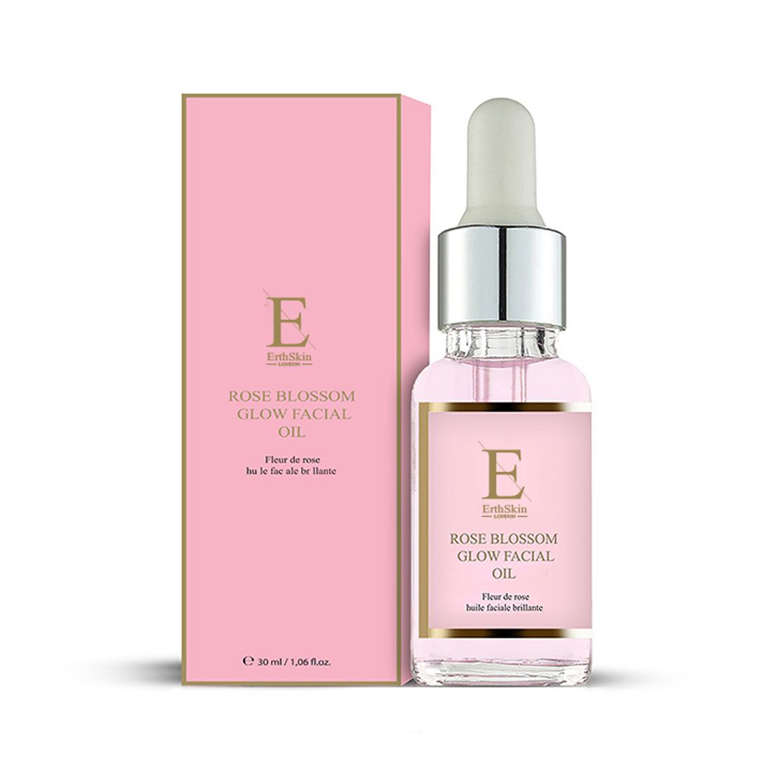 Glasflasche mit Pipette und rosafarbene Produktverpackung. Etikett zeigt 'Rose Blossom Glow Facial Oil'.