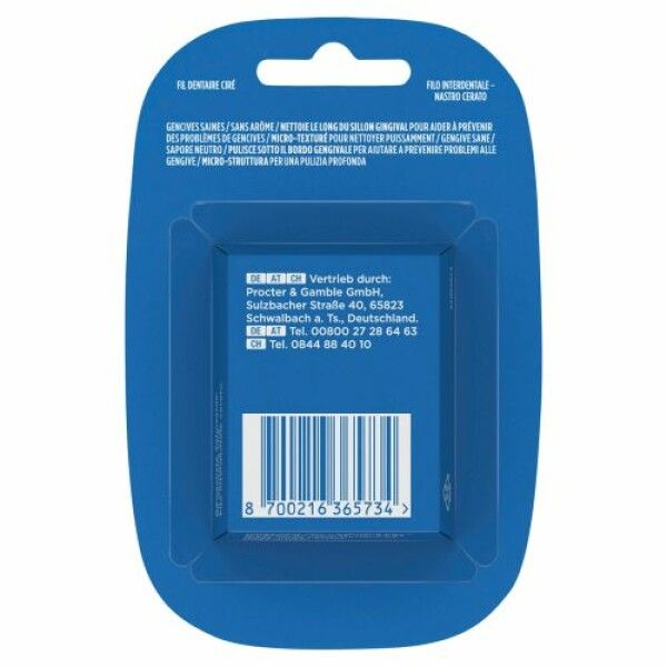 Rückseite der Zahnseide-Verpackung. Blaue Verpackung mit Text und Barcode. Text: Vertrieb durch Procter & Gamble GmbH.