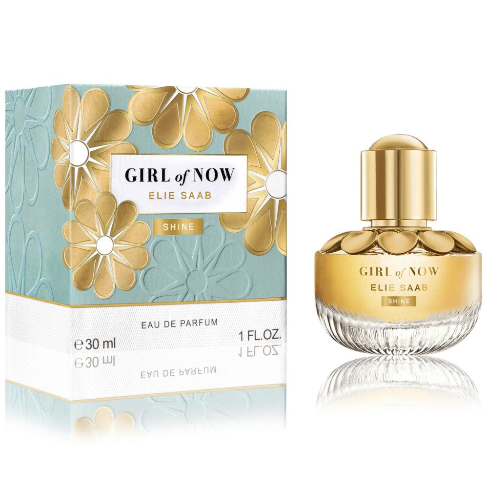 Elie Saab Girl of Now Shine EdP Nat. Spray. Flakon und Verpackung. Flakon mit goldfarbenem Deckel und blassgelber Flüssigkeit. Verpackung mit Blumenmuster.