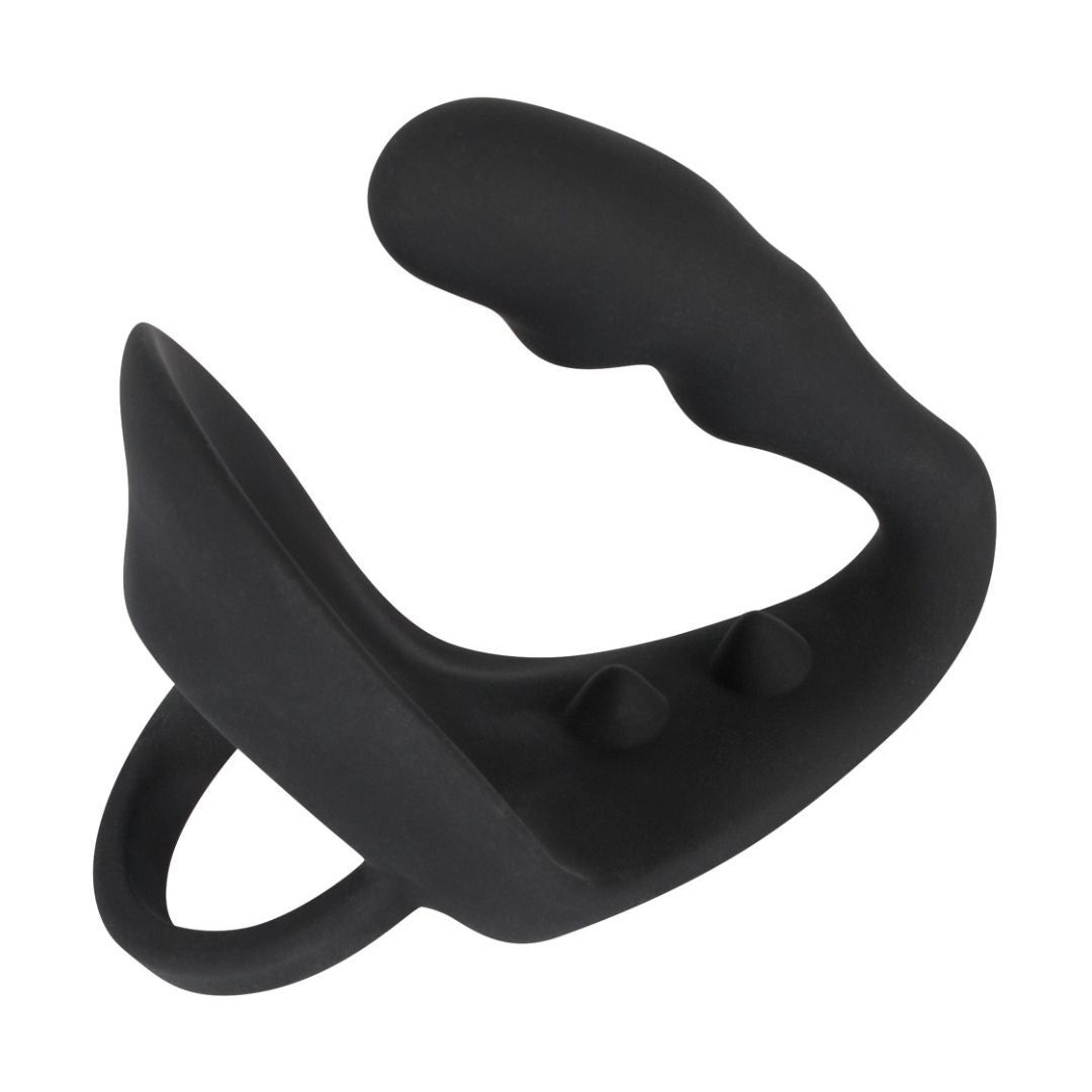 Schwarzer Penis-/Hodenring mit Analplug. Silikon. Ring- und Plug-Design mit zwei Noppen. Geschwungene Form.