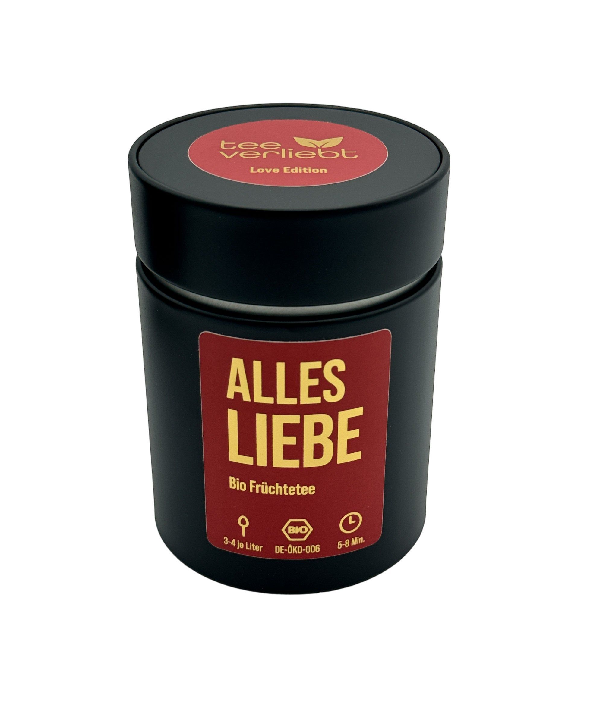 Schwarze Dose mit rotem Deckel und Aufschrift "tee verliebt Love Edition". Aufschrift "ALLES LIEBE Bio Früchtetee". Bio-Siegel.