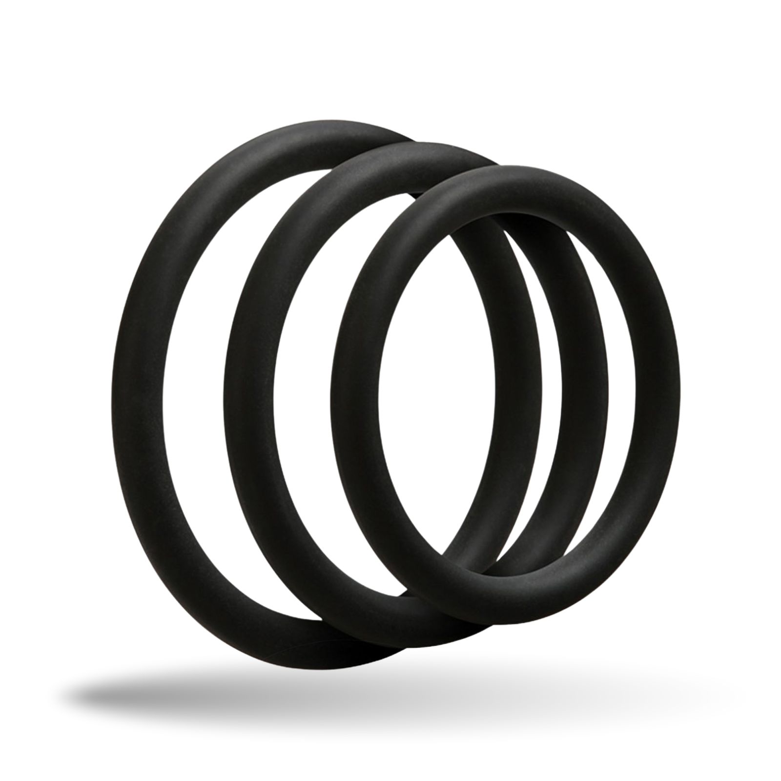 Drei schwarze Penisringe aus Silikon. Unterschiedliche Größen, nebeneinander angeordnet.