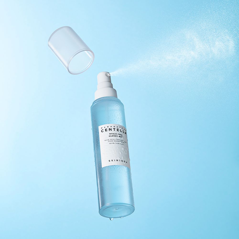 Blau-transparente Sprühflasche, Sprühnebel. Deckel daneben. Text: MADAGASCAR CENTELLA, HYALU-CICA Cloudy Mist, SKIN1004.