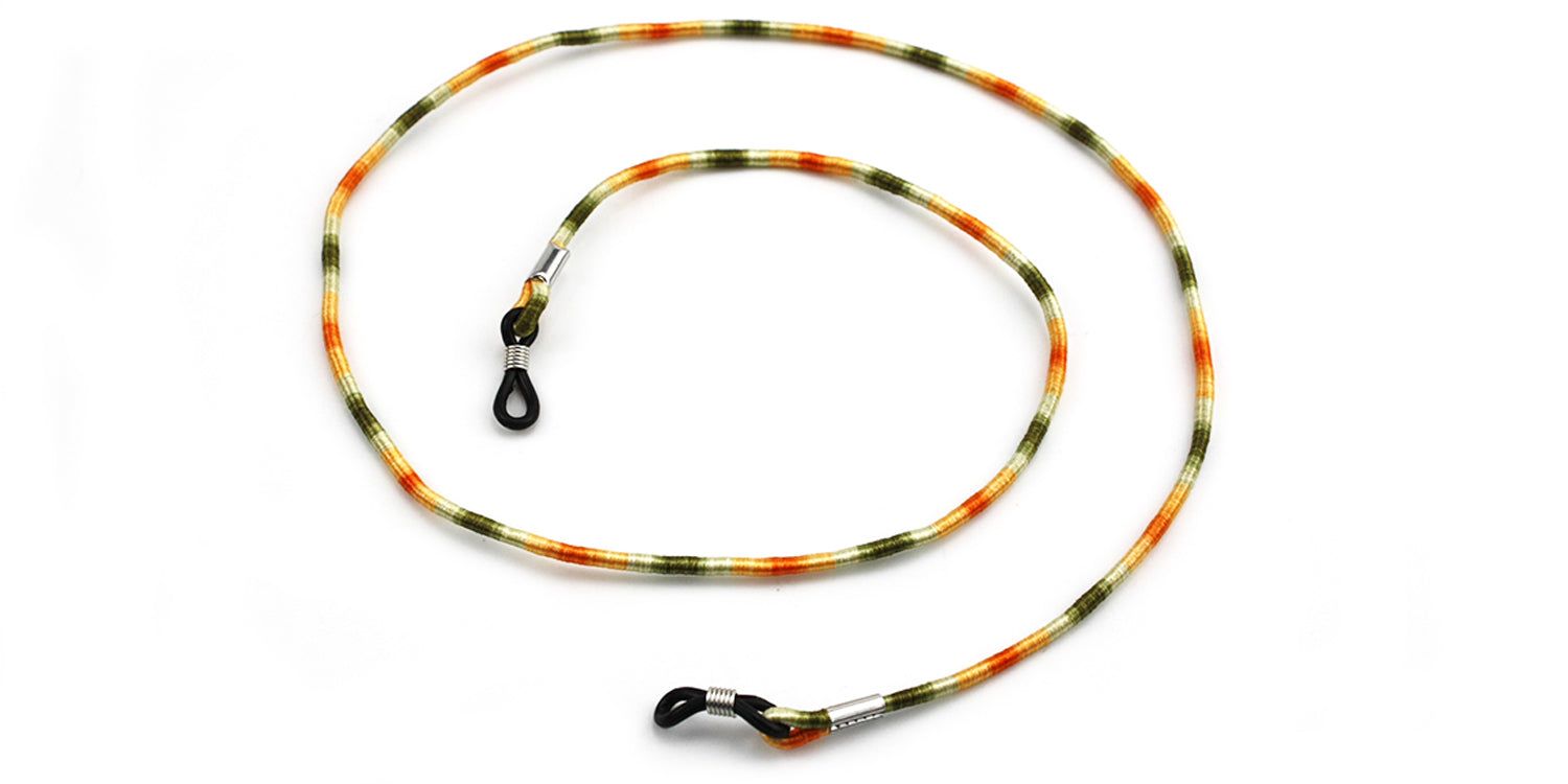 Brillenband mit farbigem Muster. Enden mit Schlaufen zur Befestigung an Brillenbügeln. Metallverbindungen.