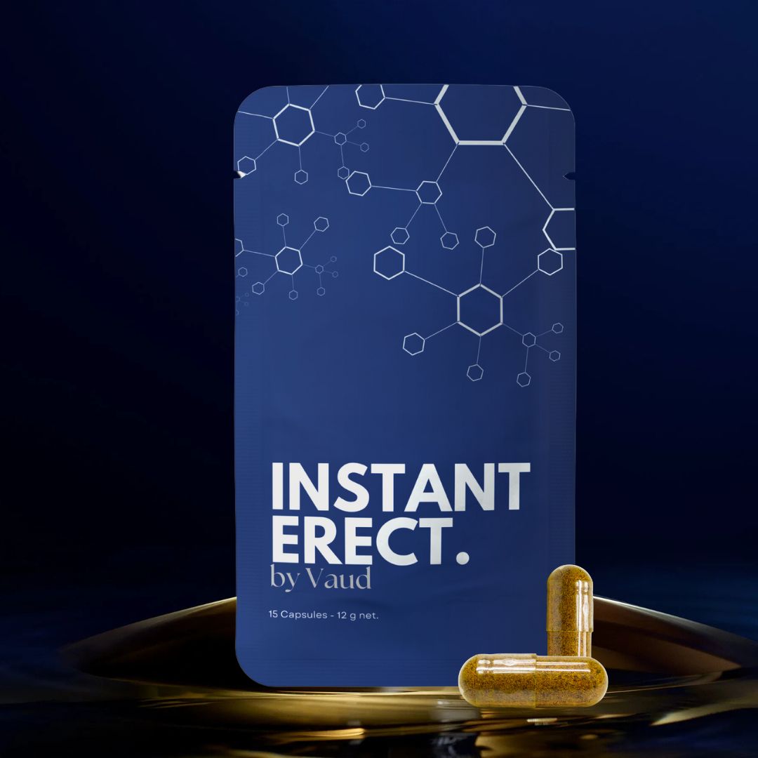Blaue Verpackung mit Text INSTANT ERECT. by Vaud. Zwei Kapseln daneben. Goldener Hintergrund.