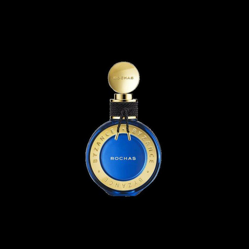 Blauer Flakon mit goldenen Akzenten. Aufschrift: Rochas Byzance. Schwarze Kordel um den Hals. Goldener Deckel.