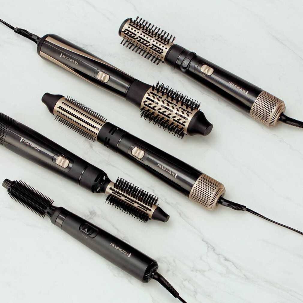 Mehrere Remington Multi-Warmluftstyler mit verschiedenen Aufsätzen. Schwarz und goldfarben. Aufsätze und Geräte mit Kabel.