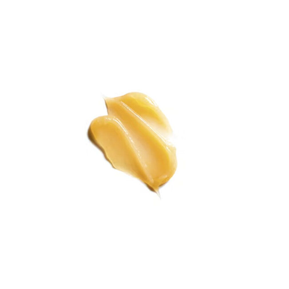 Gelbliche Creme auf weißem Hintergrund. Zwei cremige Streifen.