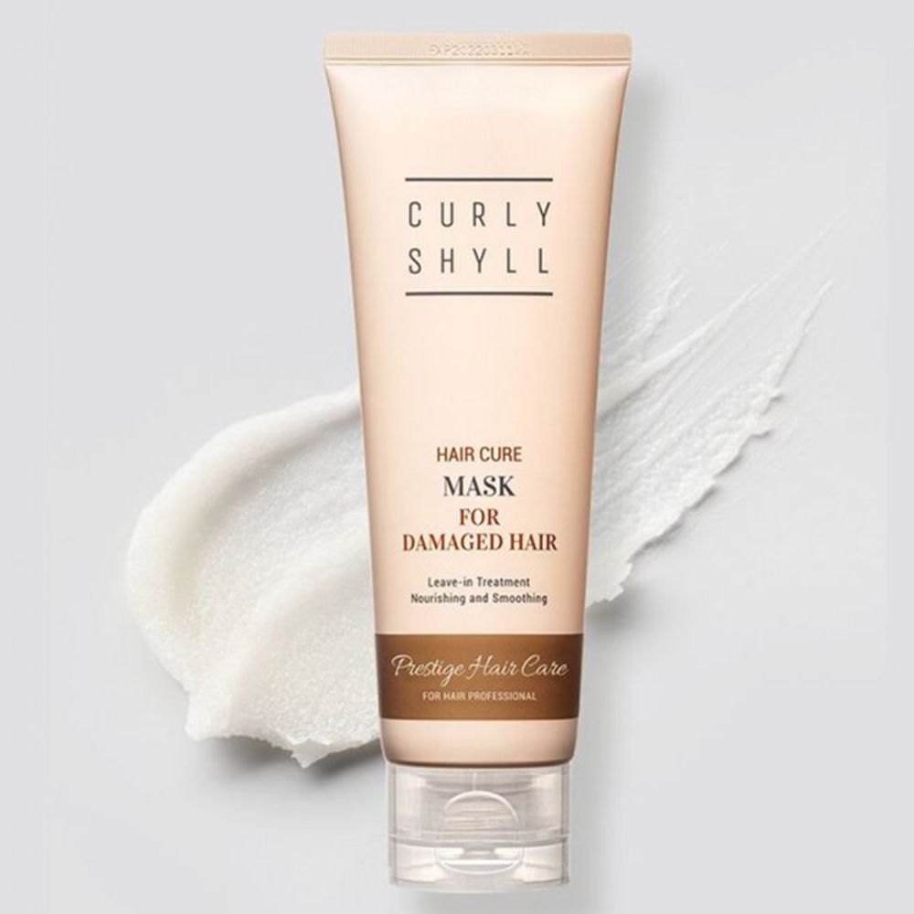 Beige Tube mit Schriftzug CURLY SHYLL. Text: Hair Cure Mask for Damaged Hair. Leave-in Treatment. Produkt auf weißem Hintergrund.