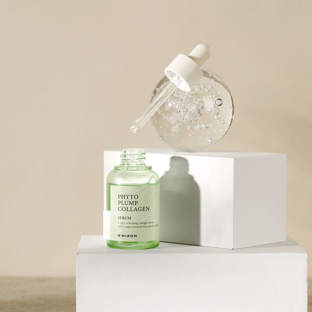 Serumflasche und Serumkugel auf weißem Podest. Produktname 'Phyto Plump Collagen' sichtbar.
