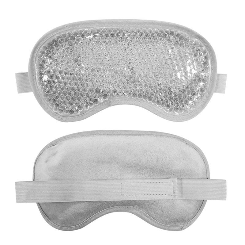 Augenmaske mit Kühlgel-Perlen. Graue, ovale Form mit elastischem Band. Rückseite aus weichem Stoff.