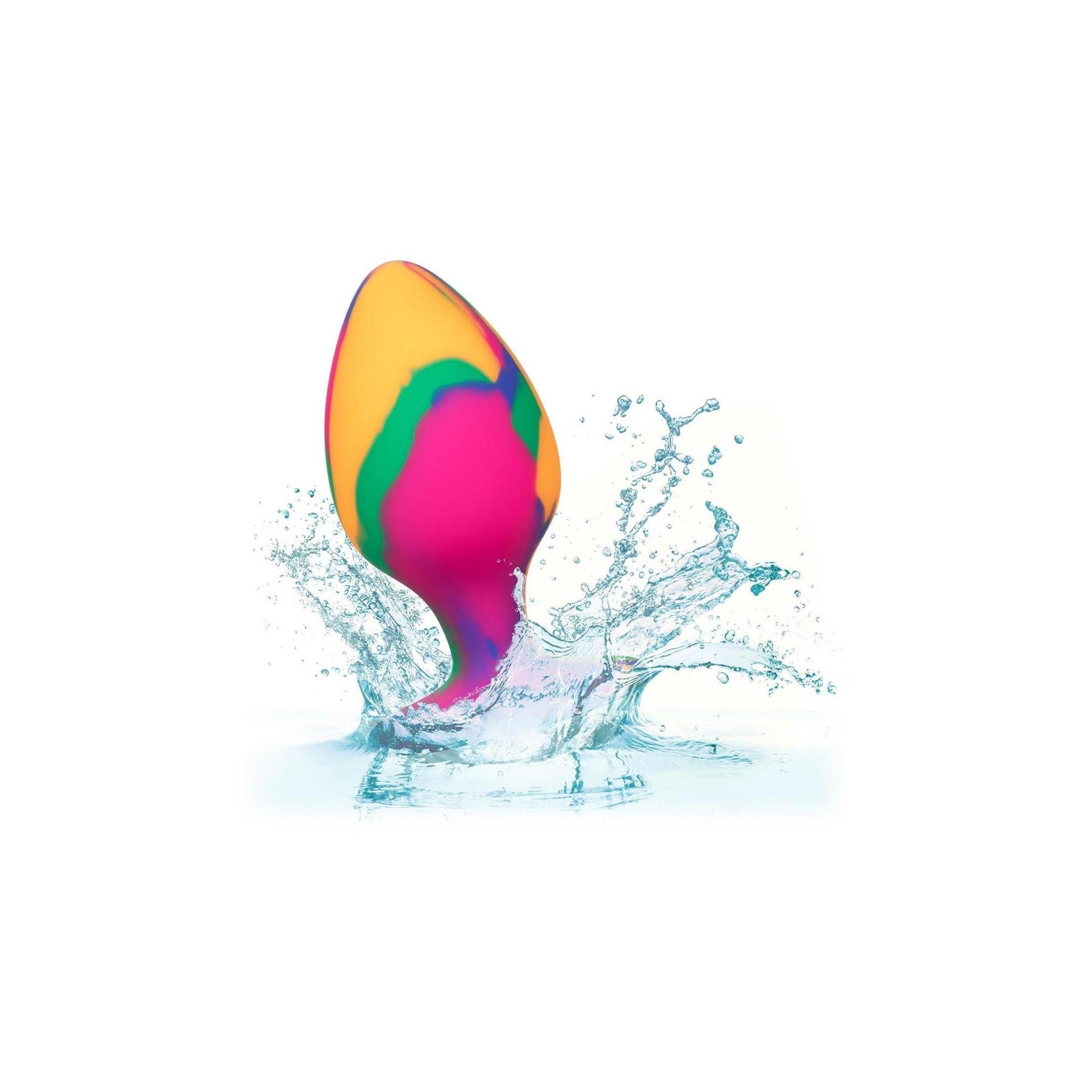 Mehrfarbiger Analplug im Wasser. Spritzer um das Produkt.
