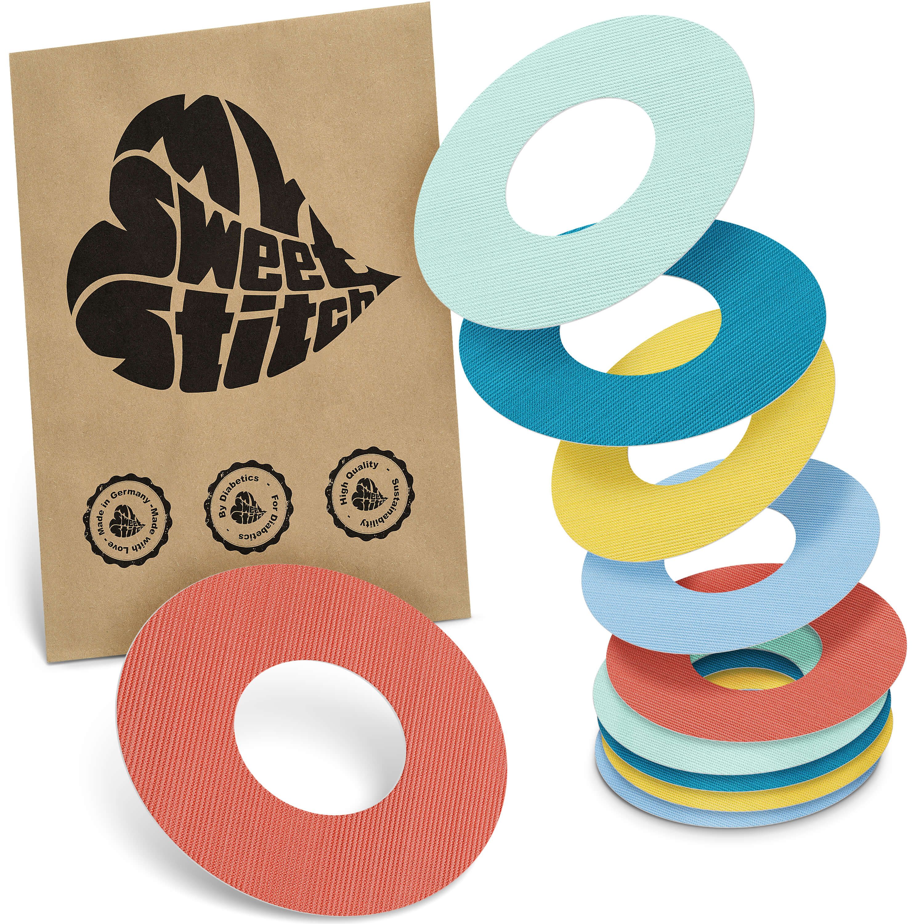 Mehrfarbige Fixierringe. Verpackung mit Logo "MySweetStitch". Ringe in Blau, Gelb, Türkis, Rot und Hellblau. Geprägte Oberfläche.