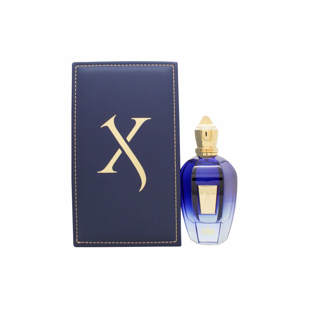 Blau-goldene Parfumflasche neben einer blauen Schachtel mit goldenem "X"-Logo. Flasche mit goldener Kappe.