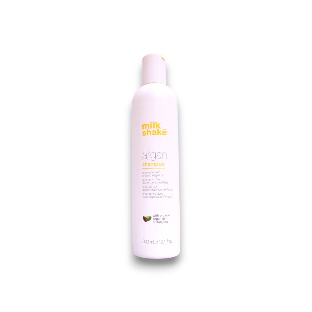 Weiße Flasche mit rosa Aufdruck. Beschriftung: milk_shake Argan Shampoo. Enthält Arganöl. 300 ml.