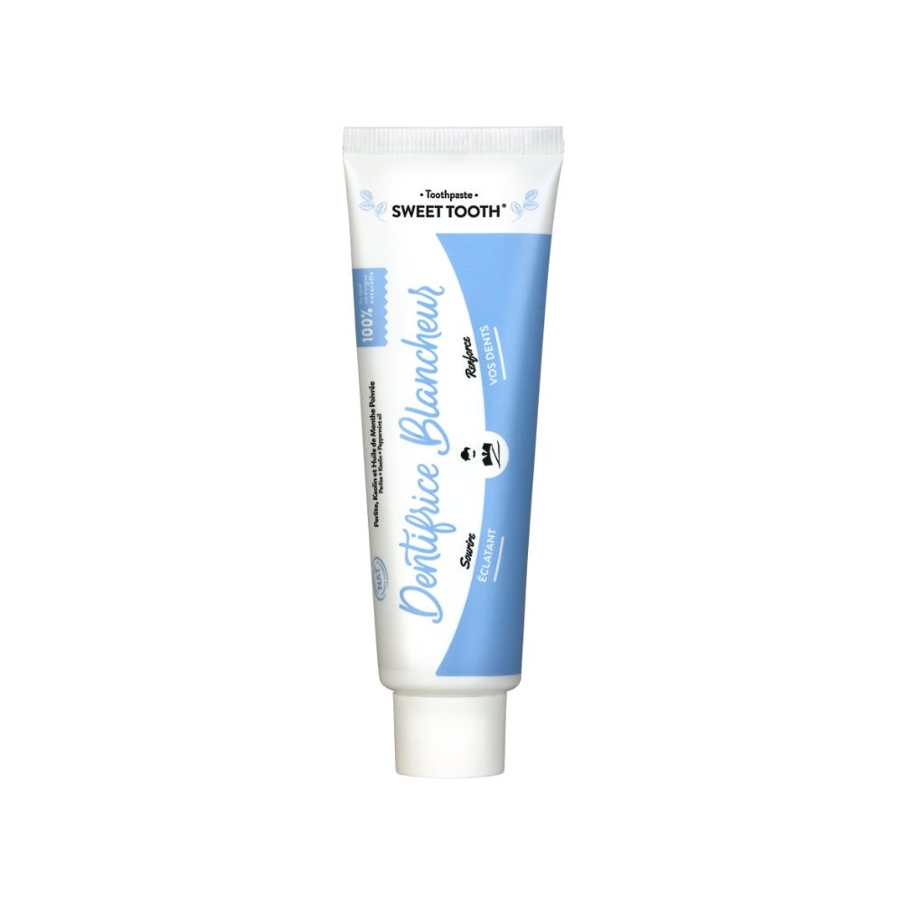 Zahncreme-Tube, weiß-blau. Aufschrift: "Dentifrice Blancheur", "Sweet Tooth".