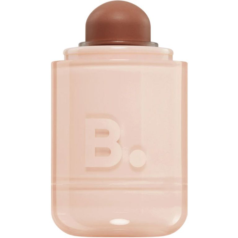 Ein zylindrischer Behälter mit einem braunen Applikator und dem geprägten Logo 'B.'.