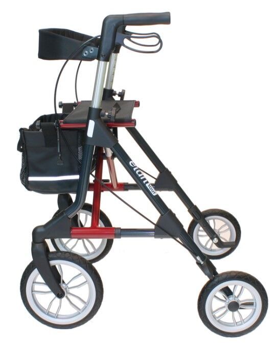 Rollator mit vier Rädern. Schwarzer Rahmen mit roten Akzenten. Marke Elan Tour sichtbar. Schwarze Tasche.