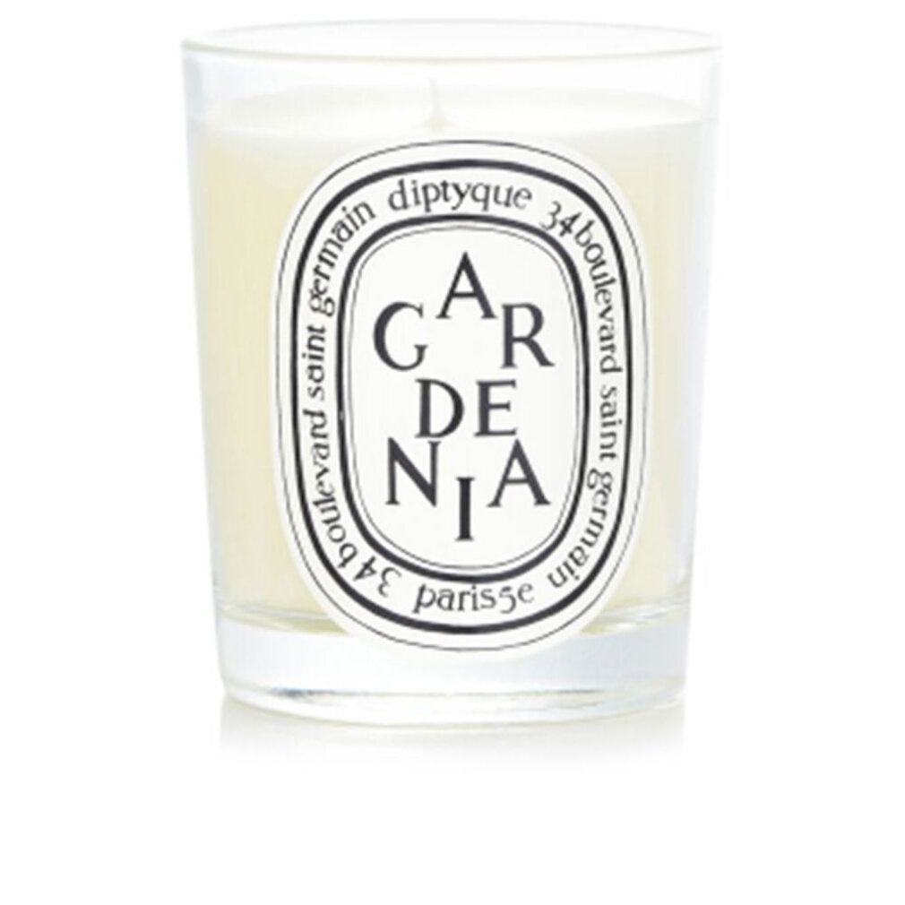 Kerzenglas mit Aufschrift GARDENIA. Weißes Wachs, schwarzes Etikett mit Markenlogo. Klarer Glasbehälter.